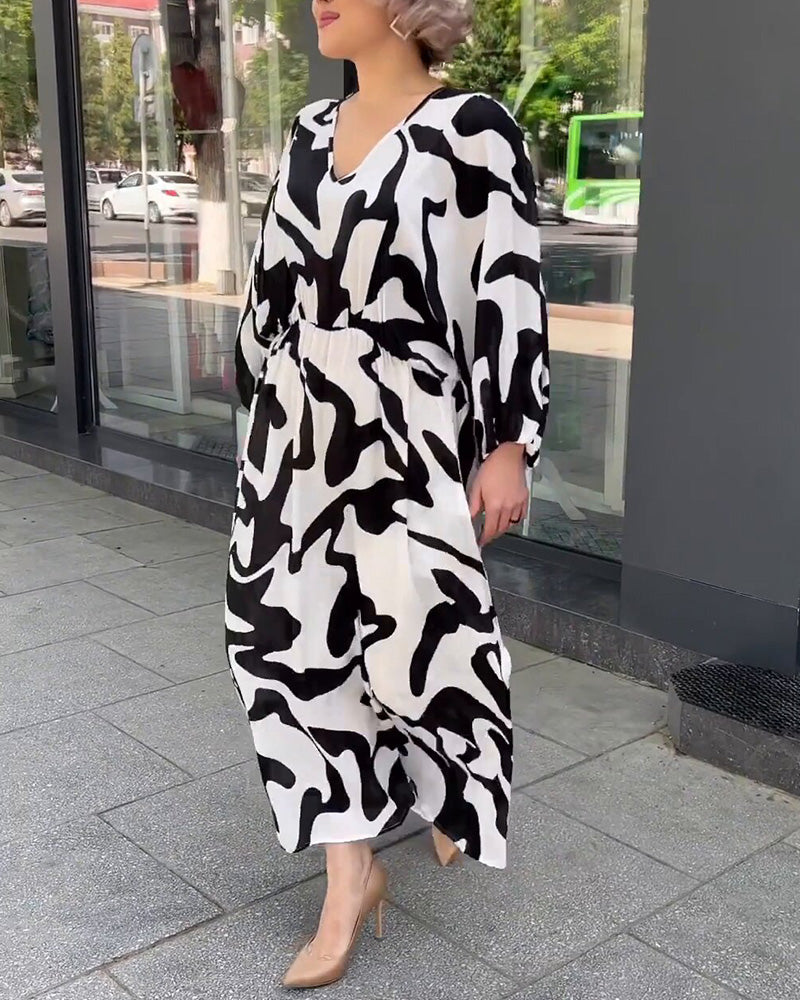 Elegant långärmad klänning i modetryck