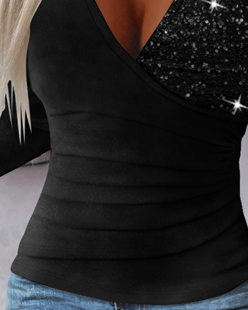 Elegant topp med v-ringad paljett och patchwork